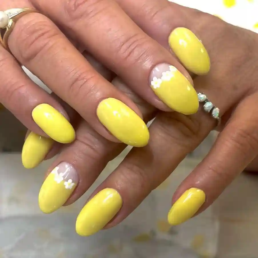 Sunny Yellow Almond Nails with White Daisy Accent