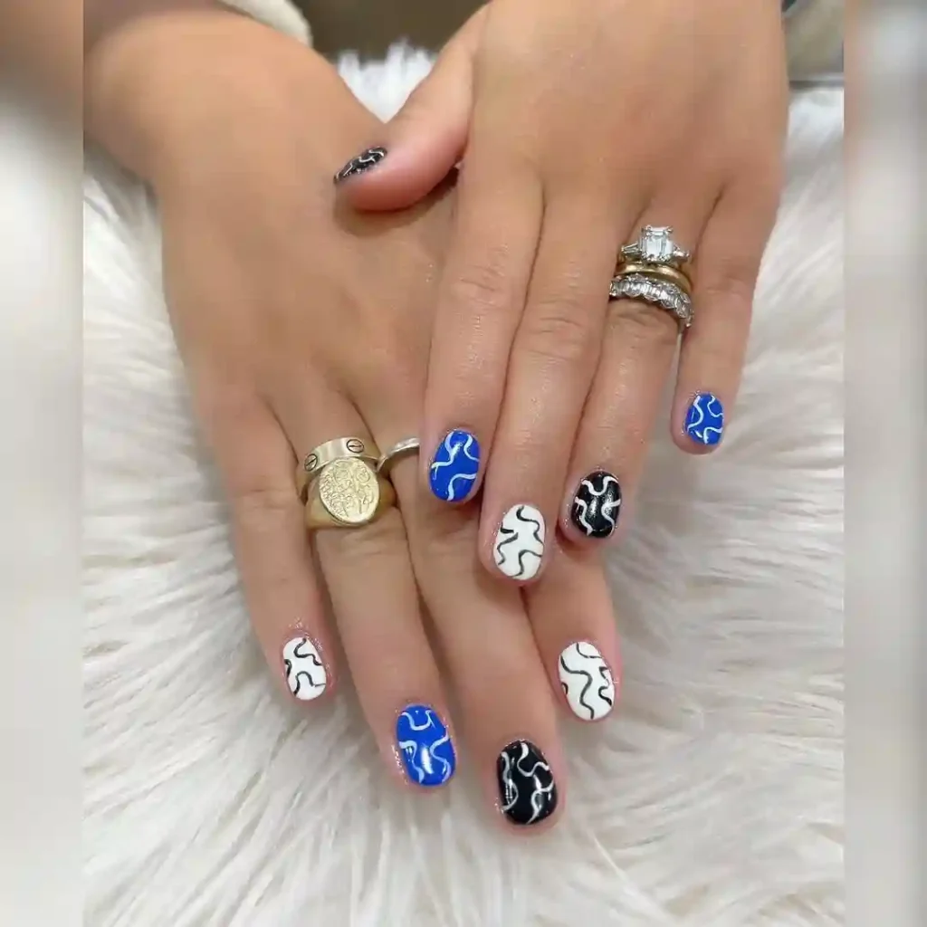 Artistic Squiggle White Nails with Pops of Blue and Black